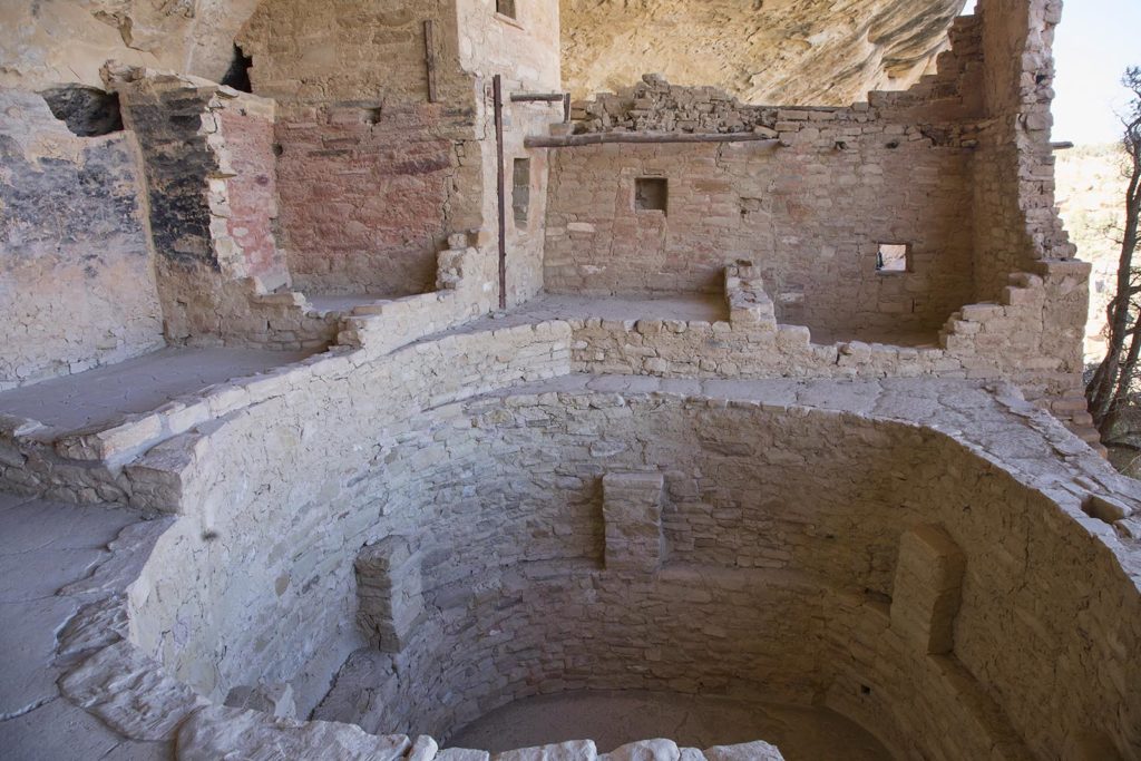 This is a view of the courtyard. The 12-foot hole in the foreground is called a kiva. It was dug out of solid sandstone and lined with bricks. Archaeologists think it had spiritual and/or cold weather lodging purposes.