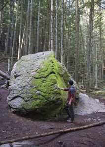 Bill standing next to one of several giant glacial boulders.