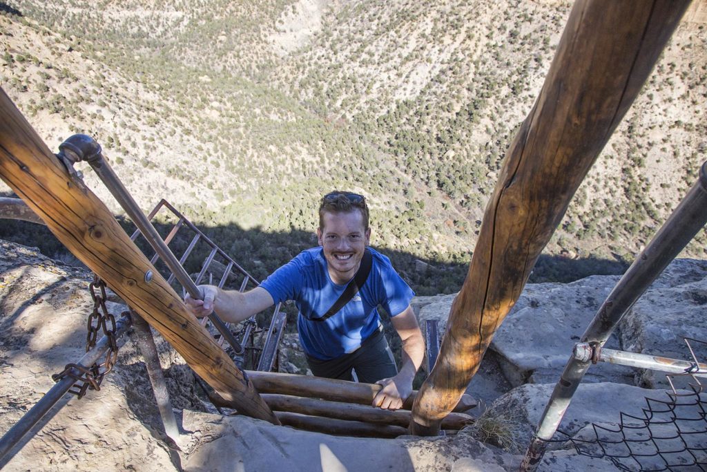 After the tunnel, we were subjected to another ladder climb. This time on the sheer rock face. You can get an idea of how high up we are in this photo of Billy reaching the top of the ladder. But the best was yet to come!