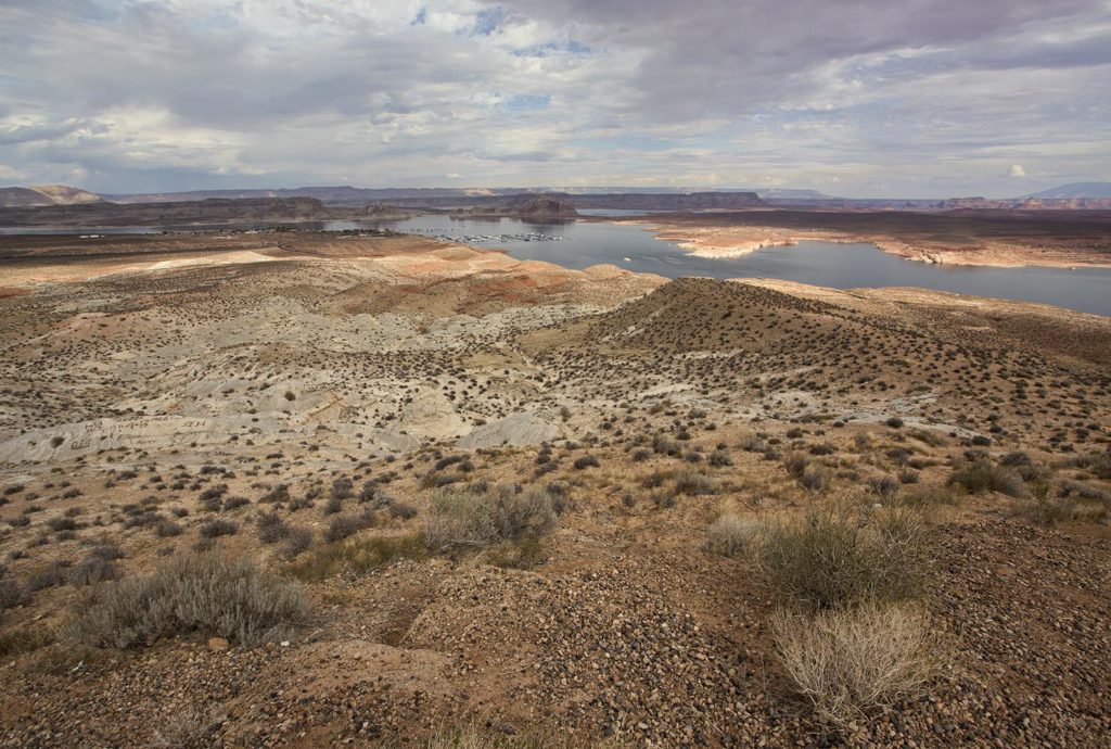 Lake Powell and distant mesas and cliffs.